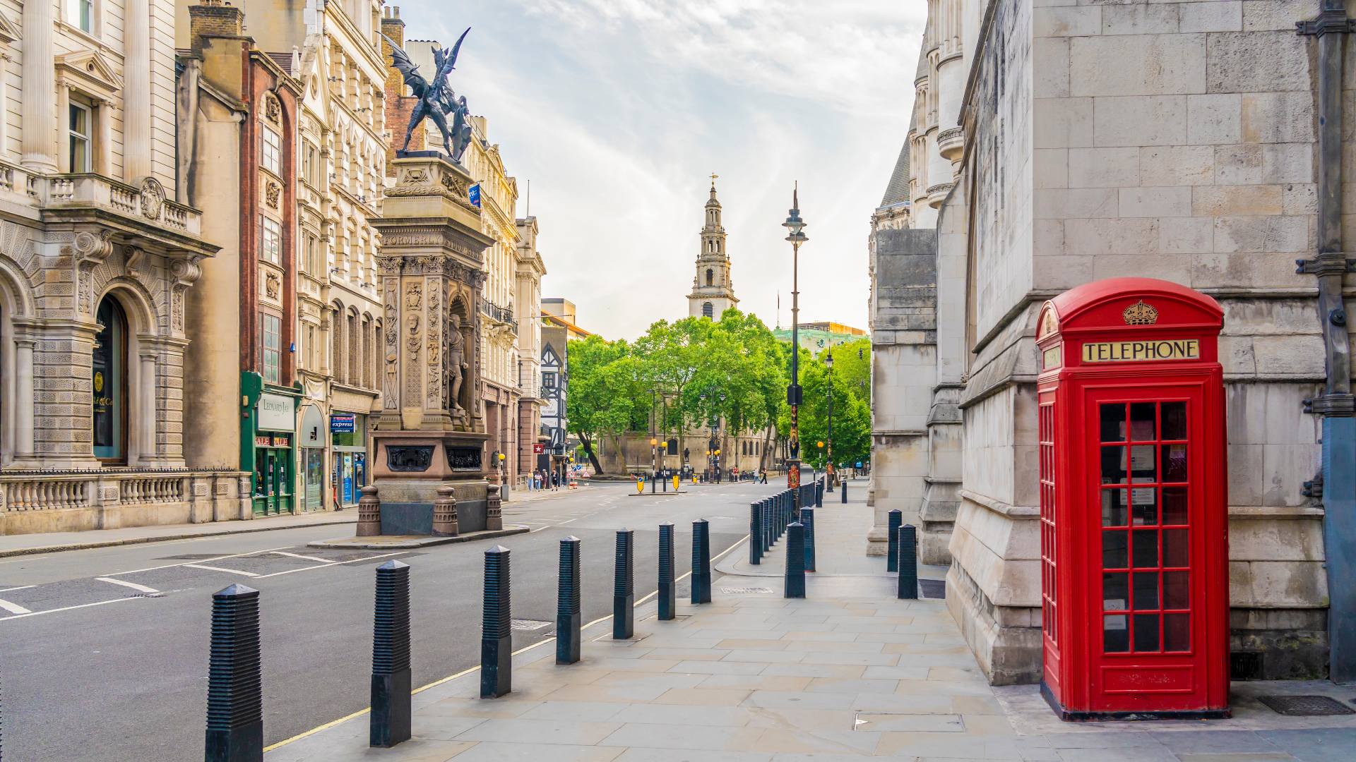 a typical view of a london street with a red phone box